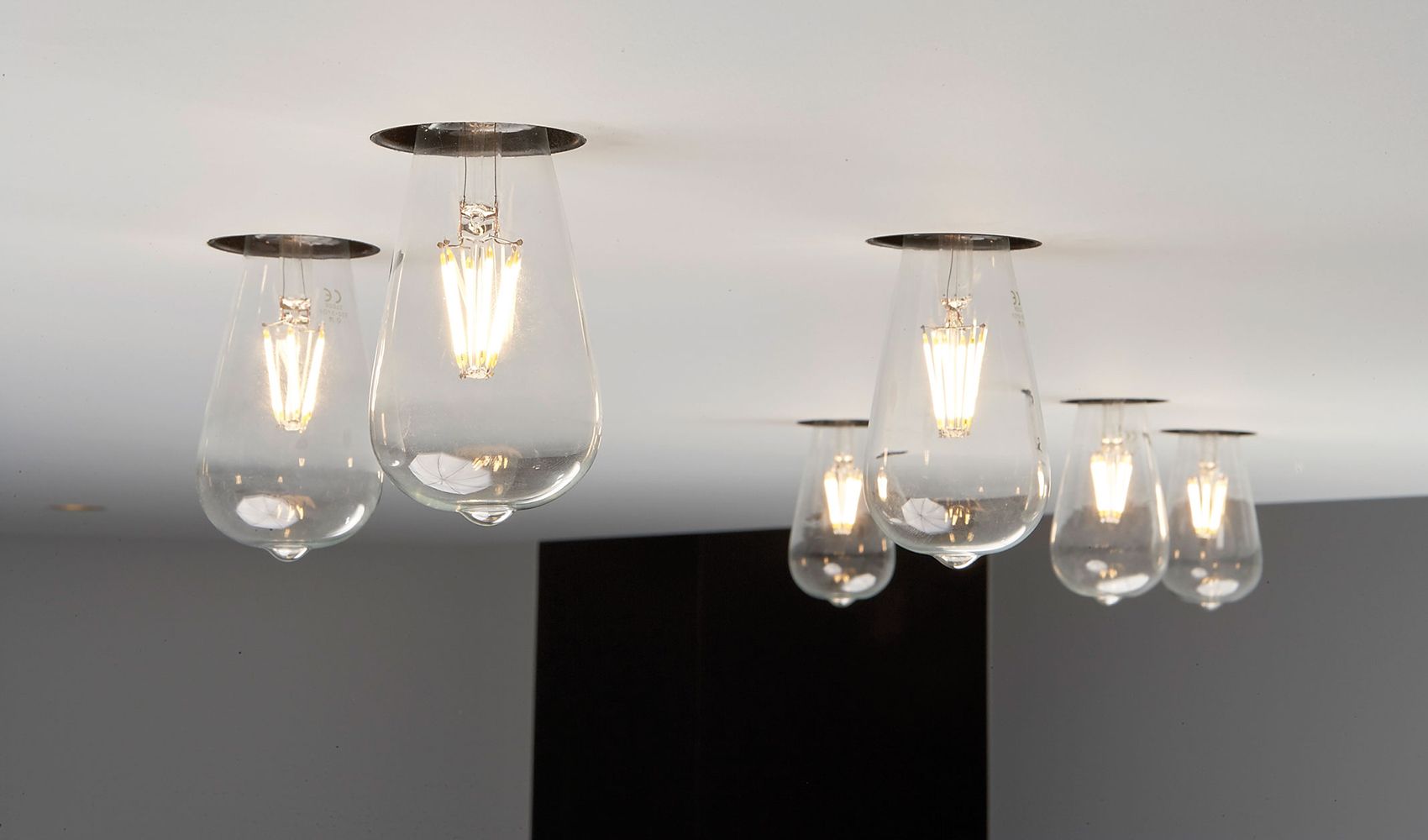 Seks Twenty7 Trimless armaturer fra Deltalight i et hvitt tak.