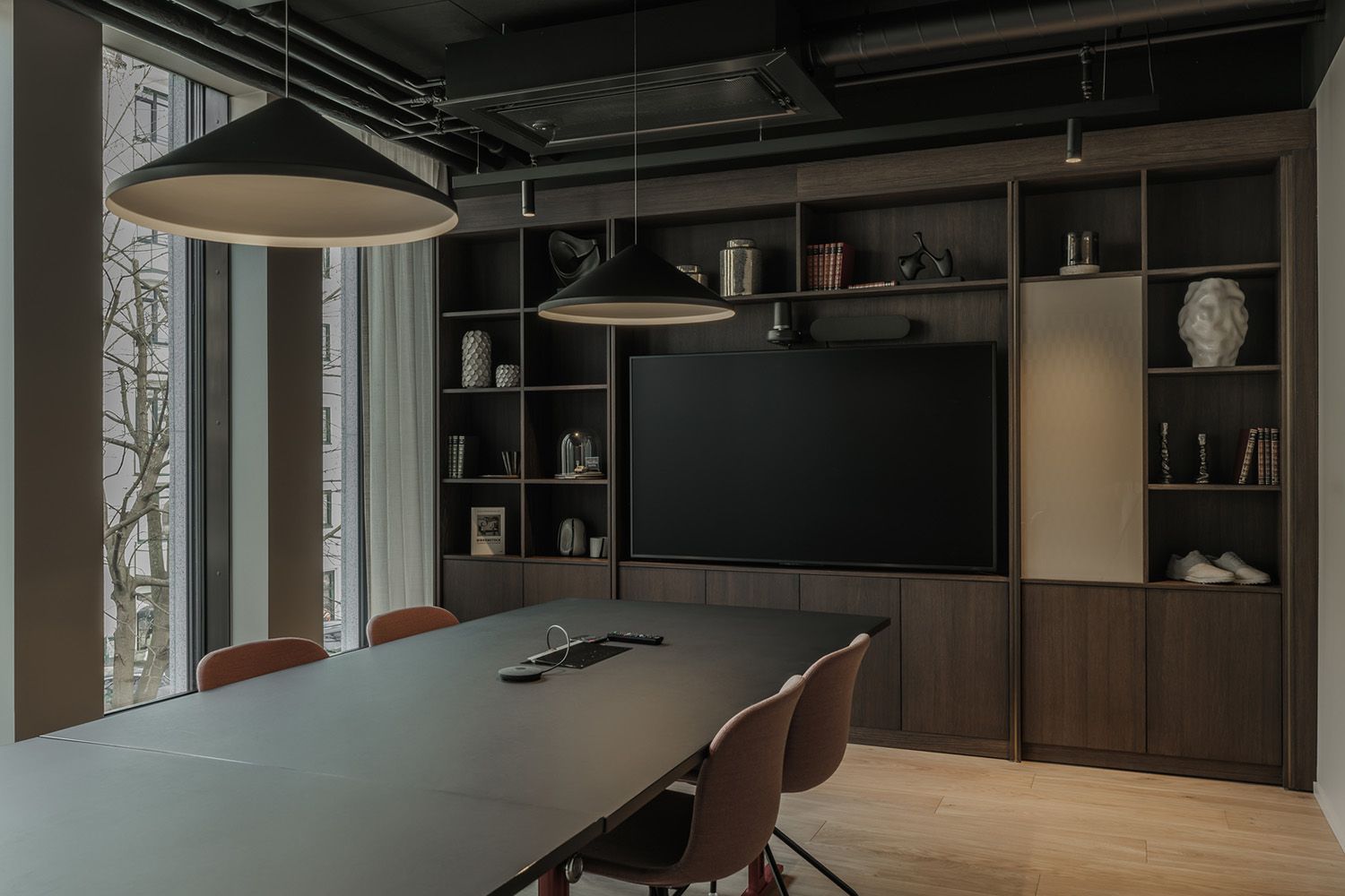 Pendler over et langt møtebord.